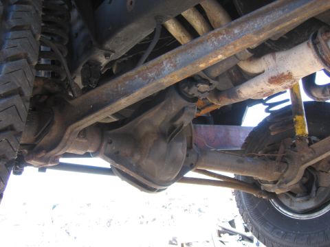 1995 Ford F-150 - The underside of a 4x4 shows its front axle, differential, and suspension system with visible rust.