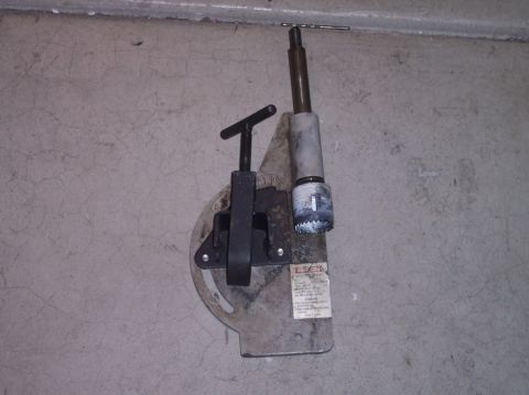1995 Ford Bronco - A close-up shows a drill press attachment with a hole saw and drill bit, mounted on a metal plate.