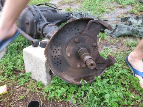 1995 Ford F-150 - A disassembled front axle differential and hub assembly rests on the grass.
