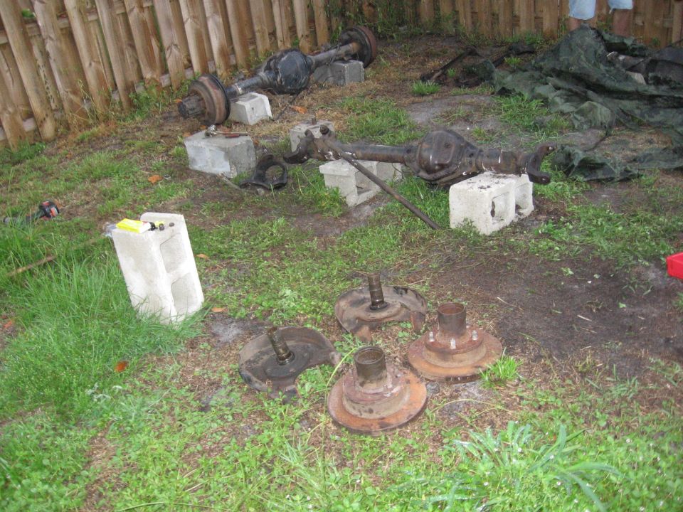Two front axle assemblies and four hubs on grass
