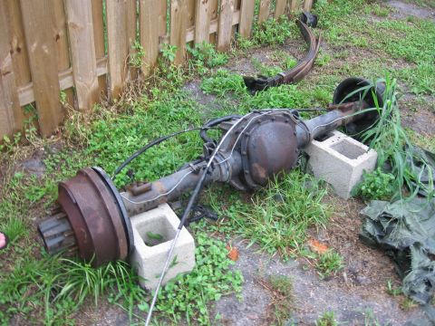 1995 Ford F-150 - Rear axle assembly and leaf spring from a Ford truck, likely removed for repair or replacement.