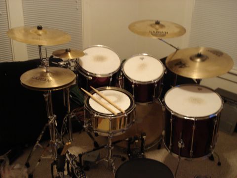 1986 Ford Bronco - A drum set with multiple drums and cymbals is shown, with drumsticks resting on the snare.