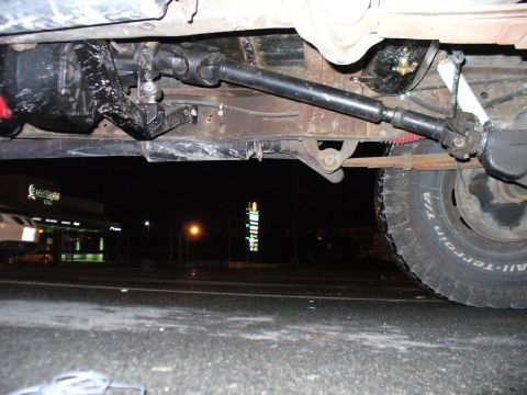 1978 Ford Bronco - Undercarriage view focusing on the rear driveshaft, differential, and leaf spring suspension system.