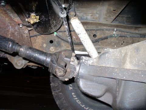 1978 Ford Bronco - Underside view of a vehicle's drivetrain components, including the driveshaft and differential.