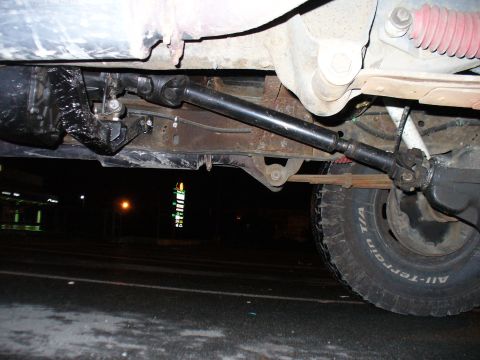 1978 Ford Bronco - The photo shows the driveshaft connecting to the rear axle of a vehicle, with a tire in view.