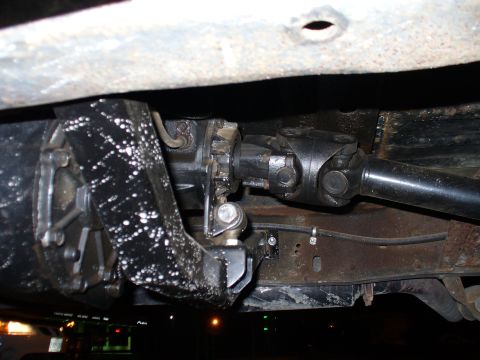 1978 Ford Bronco - Underside view of a vehicle's rear driveshaft and differential assembly.
