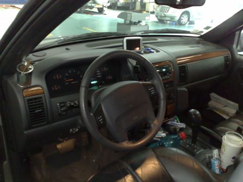 1991 Ford Crown Victoria - The interior of a Jeep Grand Cherokee, wood trim accents and a dashboard with visible gauges and controls.