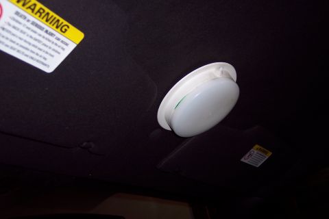 2001 Ford Crown Victoria - Interior view of a vehicle's headliner with a light fixture and warning labels.
