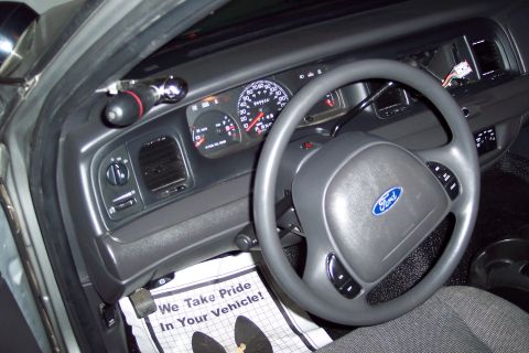 2001 Ford Crown Victoria - The interior of a 2001 Ford Crown Victoria, a Ford-branded steering wheel and a clear view of the instrument panel.