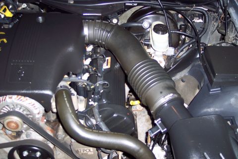 2001 Ford Crown Victoria - Close-up view of a vehicle's engine bay, showing various components and hoses.