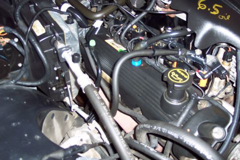 2001 Ford Crown Victoria - Close-up view of a Ford V8 engine bay, showing the valve covers and associated plumbing.