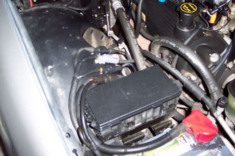 2001 Ford Crown Victoria - Close-up view of engine bay components including a fuse box and battery terminal.