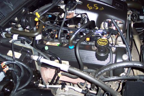 2001 Ford Crown Victoria - Engine bay detail with "6.5" oil written on the black cover.