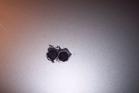 2001 Ford Crown Victoria - Two circular sensors are visible on the metallic silver exterior of a vehicle.