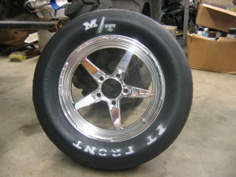 1992 Ford Mustang - A close-up of a chrome five-spoke wheel with a M/T tire, with "FRONT" printed on the sidewall.
