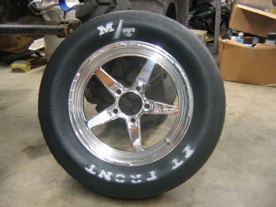 Chrome five-spoke wheel with M/T tire, showing "FRONT" text