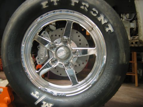1992 Ford Mustang - Close-up of a drag racing tire and wheel assembly, including the brake system.
