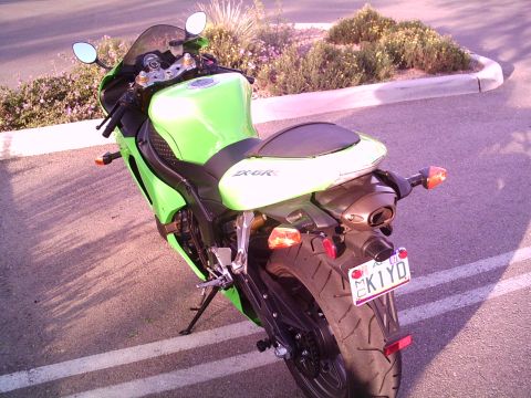 2005 Kawasaki Ninja R - A green Kawasaki motorcycle is parked on the side of the road, with a license plate visible.