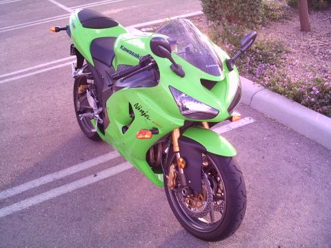 2005 Kawasaki Ninja R - A green Kawasaki Ninja motorcycle is parked in a lot, showing its front 3/4 view.