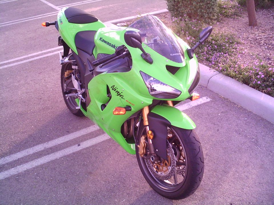 Lime green Kawasaki Ninja 600 sportbike parked in a lot, three-quarter front view