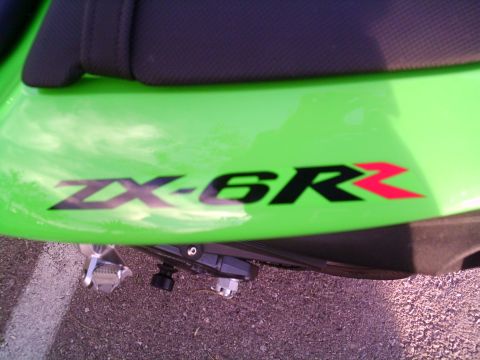 2005 Kawasaki Ninja R - Close-up of a Kawasaki ZX-6R badge on a green motorcycle panel.