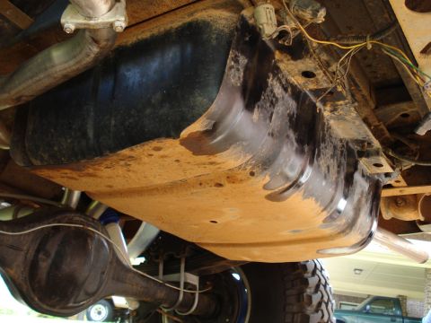1984 Ford Bronco - Underside view of a 1984 Ford Bronco, showing the fuel tank and rear axle assembly.