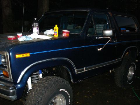 1984 Ford Bronco - This 1984 Ford Bronco is shown in a dark blue finish with cleaning supplies staged on its hood.