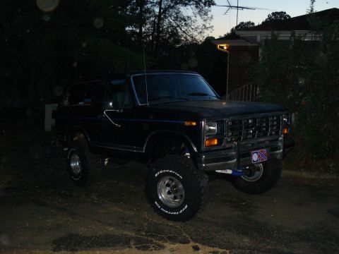 1984 Ford Bronco - This lifted 1984 Ford Bronco is seen from a three-quarter front view at dusk.