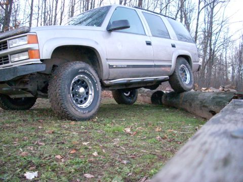 2000 Chevrolet Tahoe - This silver SUV, likely a 1995 Chevrolet Tahoe, navigates an off-road course by driving over large logs.
