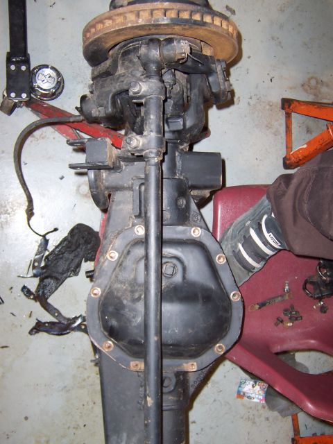 1990 Ford Bronco - Close-up of a vehicle's front axle assembly, likely undergoing maintenance or repair.