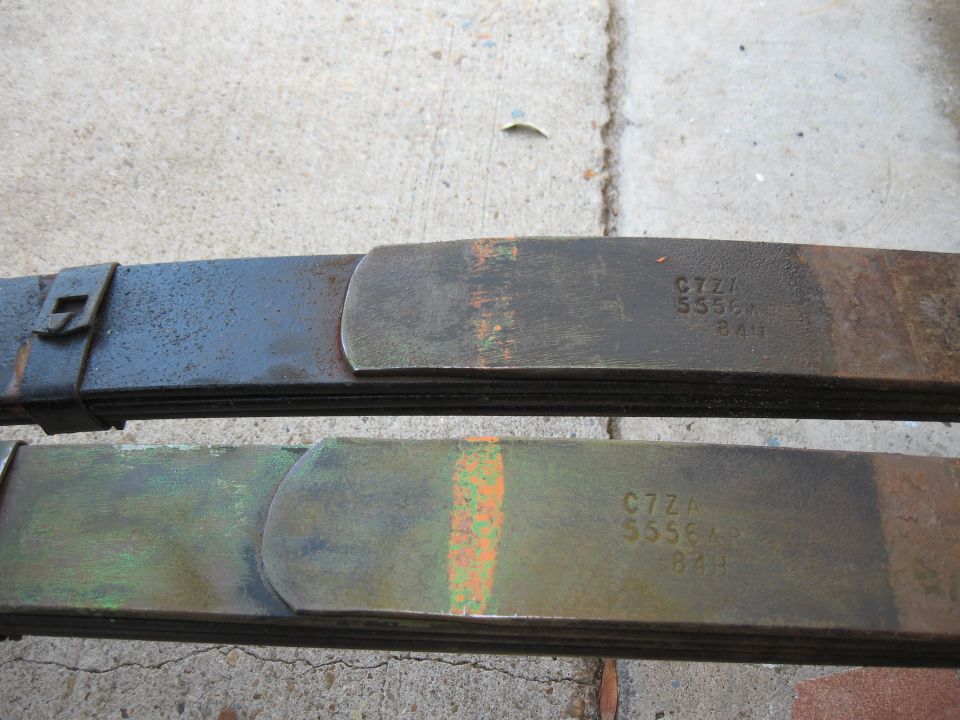 Two metal leaf springs with stamped part numbers C7ZA S556A 84H