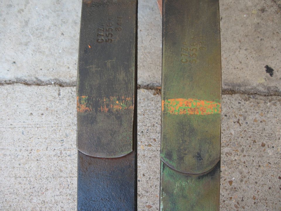 Two metal suspension parts with stamped numbers C7ZZ 3556