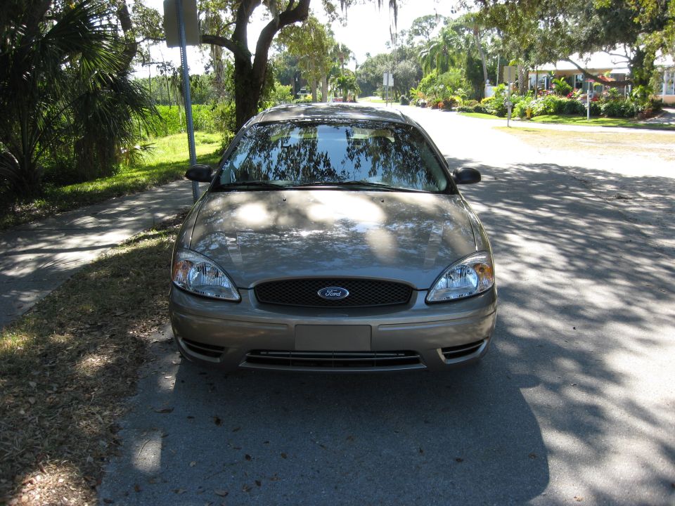 Front view of a tan 2002 Ford Taurus parked on a street