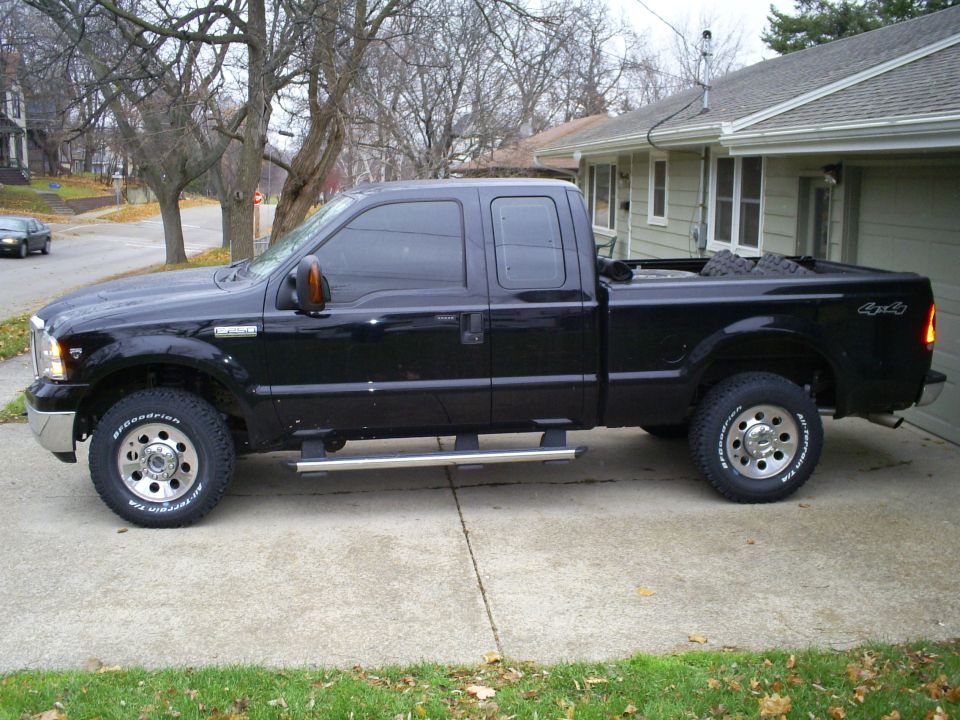 Black pickup truck side view. BFGoodrich tires visible