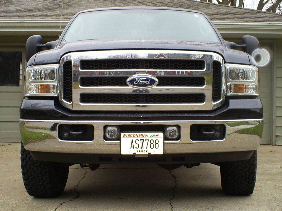 Front view of a dark blue Ford Super Duty truck with a chrome grille and Wisconsin license plate AS7788