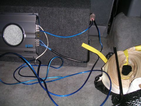 1994 Ford Bronco - The image shows a car audio amplifier and subwoofer with visible wiring, likely installed in the trunk of a vehicle.