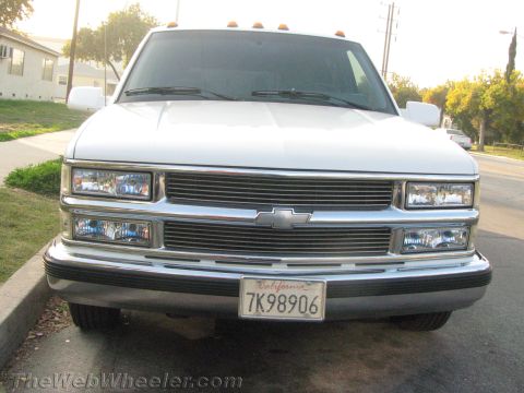 1994 Chevrolet Silverado 3500 - Front view of a white Chevrolet pickup truck with a chrome grille and amber marker lights on the roof.