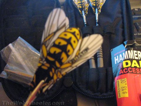 1968 Ford Mustang - A dart with a wasp design is displayed in a black dart case alongside other darts and a package of dart accessories.