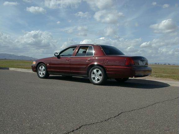 Maroon 2004 Ford Crown Victoria sedan, rear three-quarter view, parked roadside