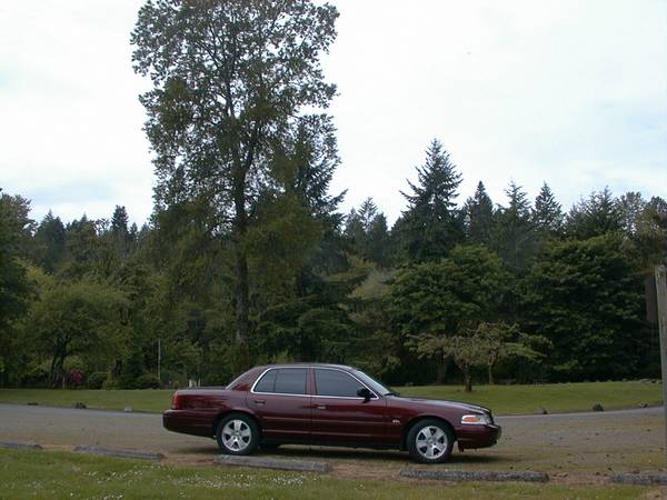 Maroon 2004 Ford Crown Victoria sedan, side view, parked outdoors