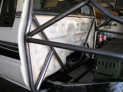 1986 Toyota Hilux - This white Toyota truck, likely a 1986 model, features a custom roll cage and "EFI" badging.