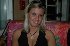 1991 Ford Bronco - A woman with blonde hair, wearing a black top and a pendant necklace, smiles for the camera.