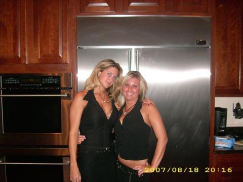 1991 Ford Bronco - Two women smile for the camera in a modern kitchen, with a large stainless steel refrigerator behind them.