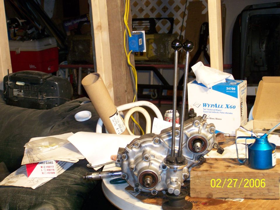 transfer case with two shifters and a blue oil can on a table