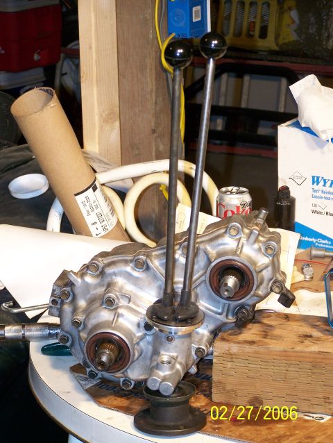 1988 Suzuki Samurai - A disassembled transfer case with dual shifters is shown on a workbench.