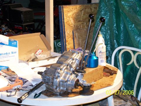 1988 Suzuki Samurai - Transfer case with dual shifters and associated parts on a table, possibly for a Suzuki Samurai.