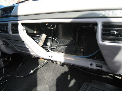 1994 Ford Bronco - The interior of a 1994 Ford Bronco shows the dashboard with the glove box open, revealing wiring and components.