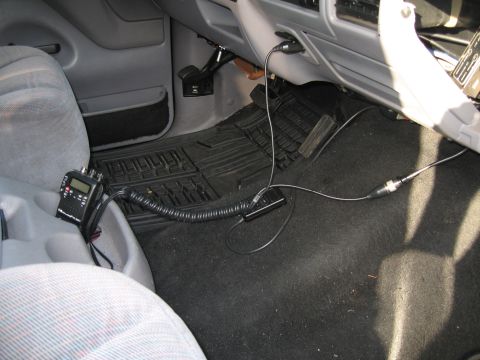 1994 Ford Bronco - CB radio and microphone installed in the passenger footwell of a vehicle.