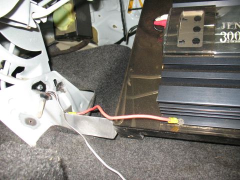 1997 Ford Crown Victoria - Wiring for a car amplifier is shown connected to a metal bracket in the trunk.