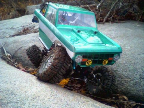 1996 Ford Bronco - This remote-controlled rock crawler, resembling a classic SUV, navigates a challenging rocky path.
